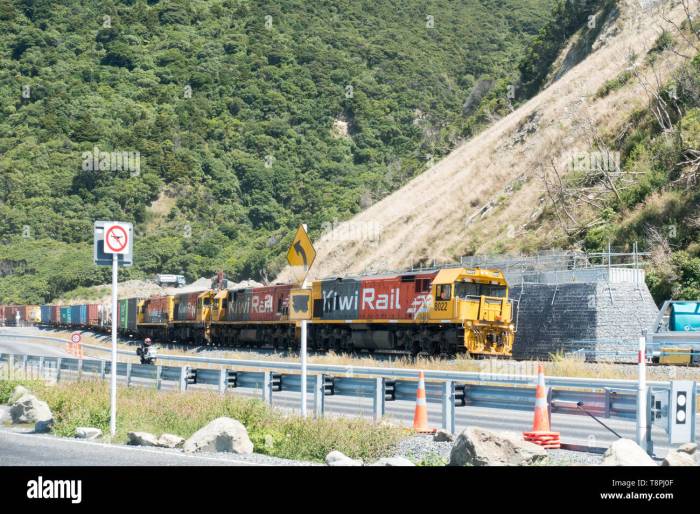 A freight train rolls along a track with considerable momentum